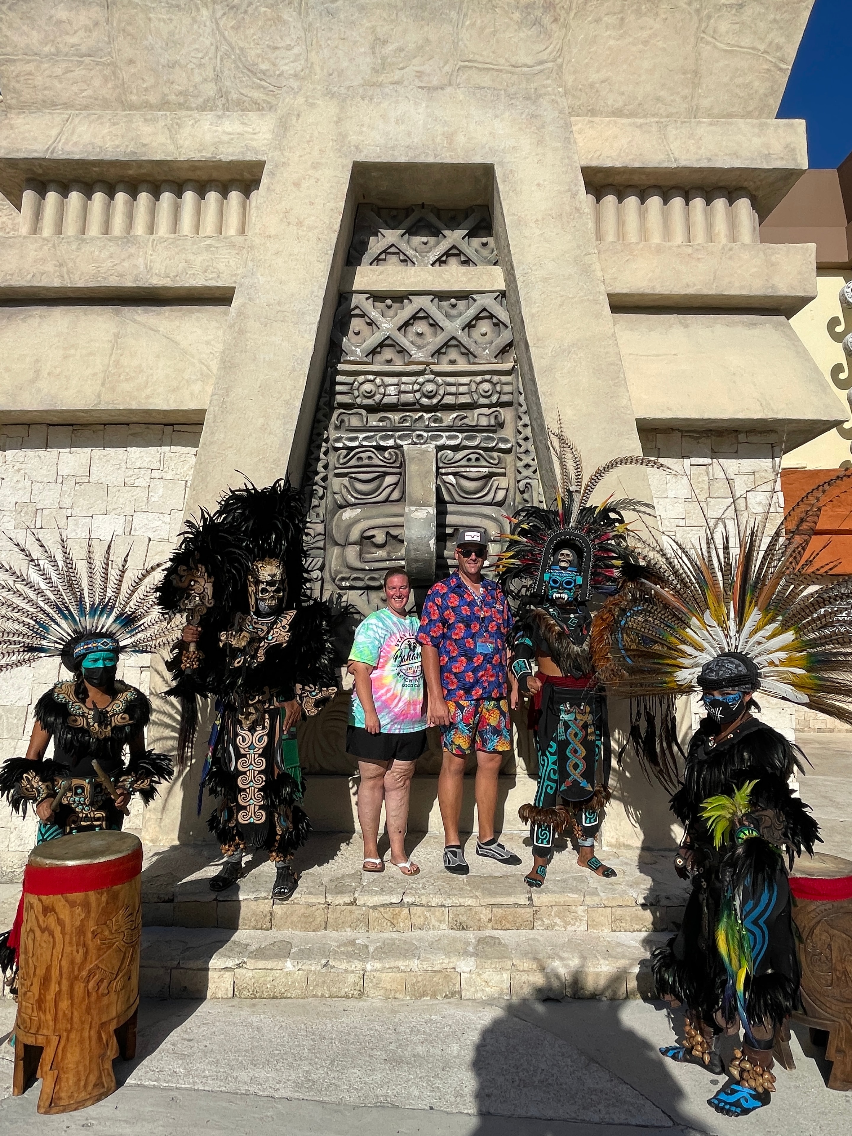 Travelers with Aztec dancers at a cultural site