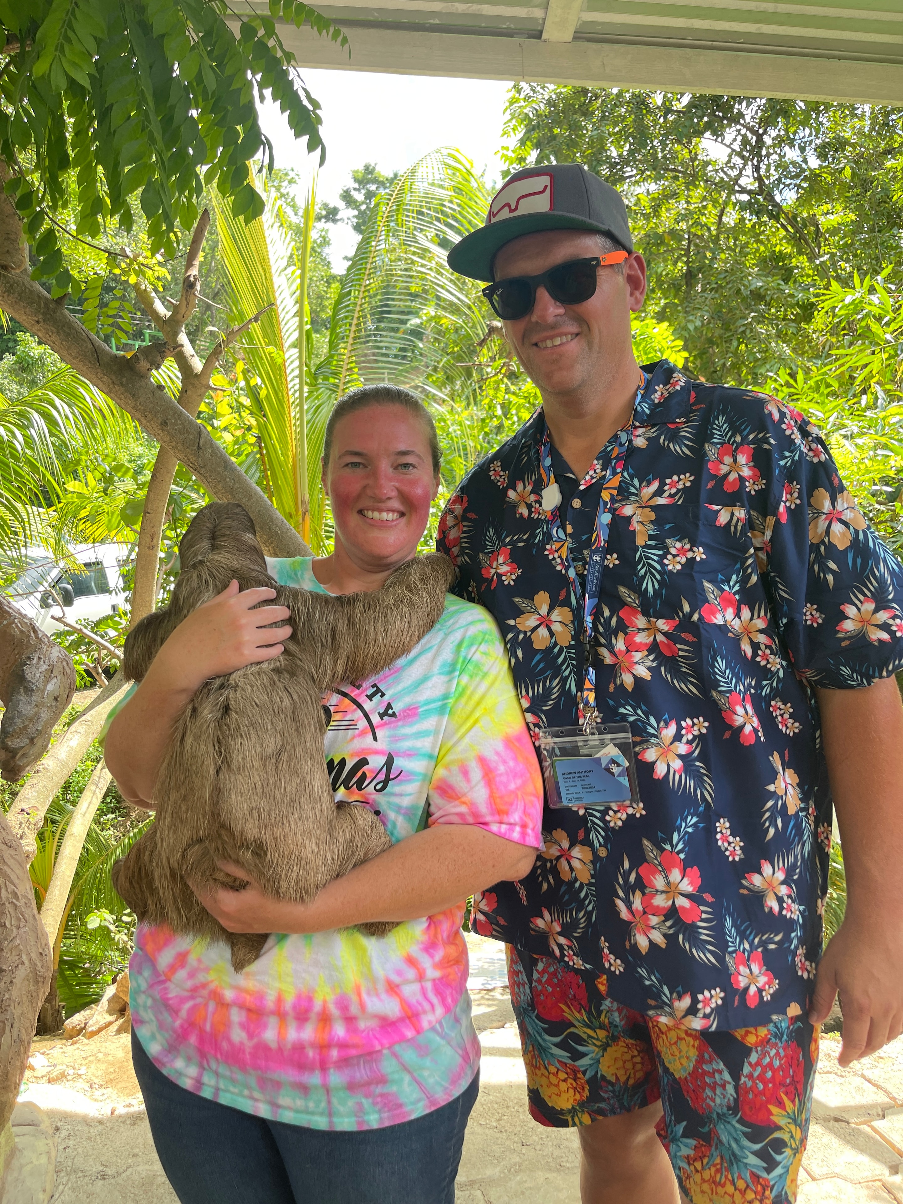 Couple holding a sloth at a wildlife encounter