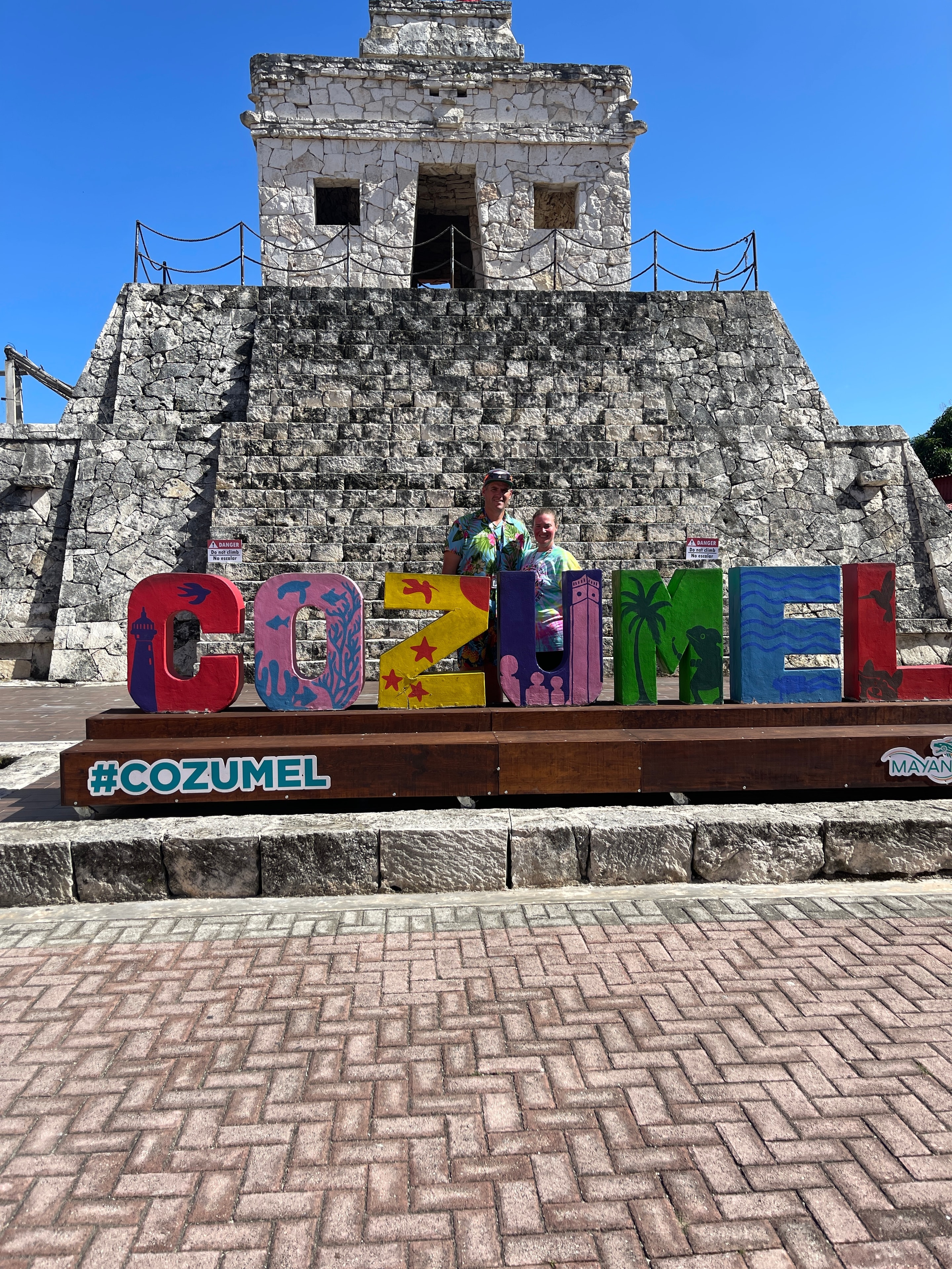 Couple at the Cozumel landmark sign