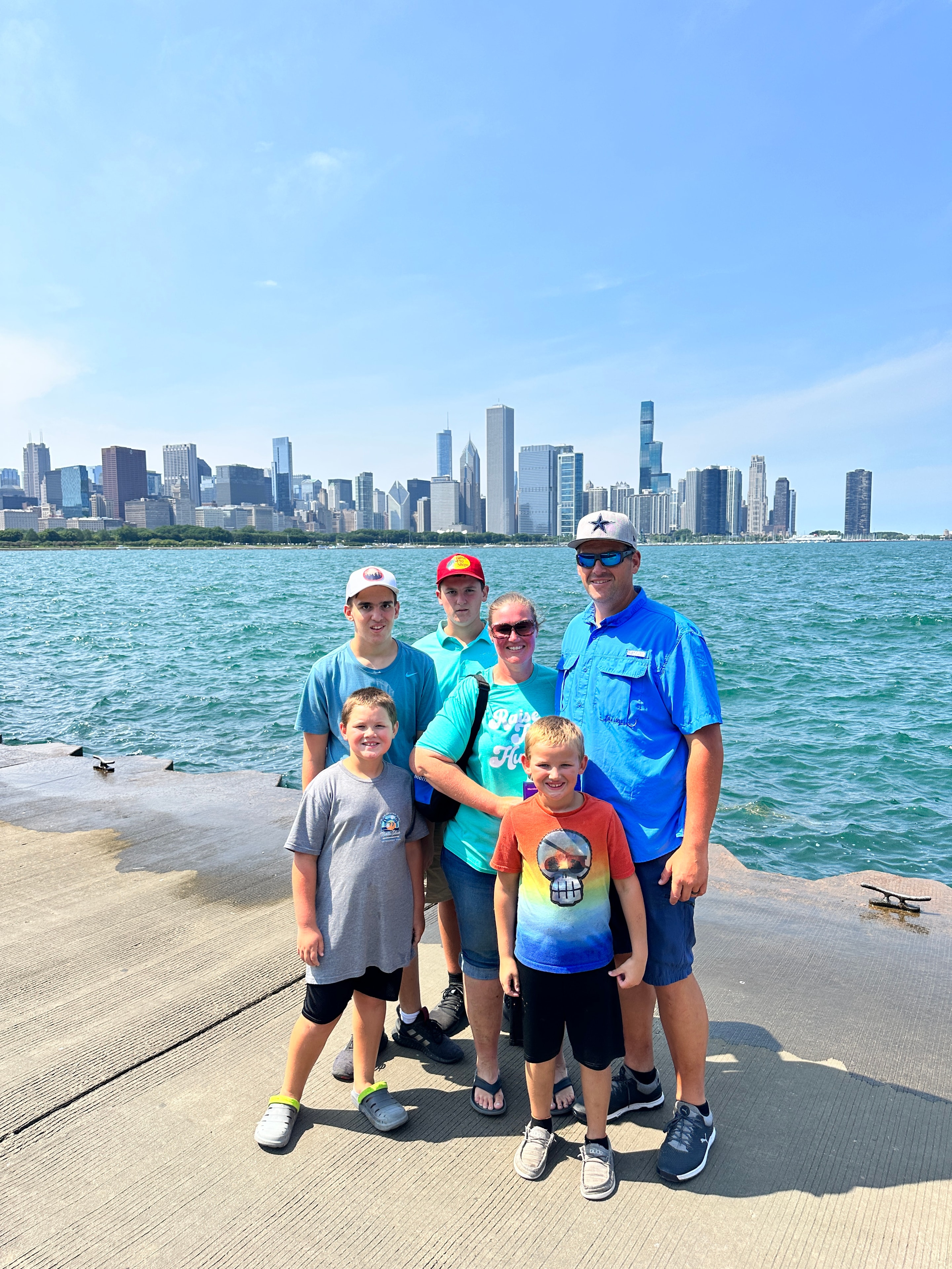 Family posing at Chicago lakefront with city skyline