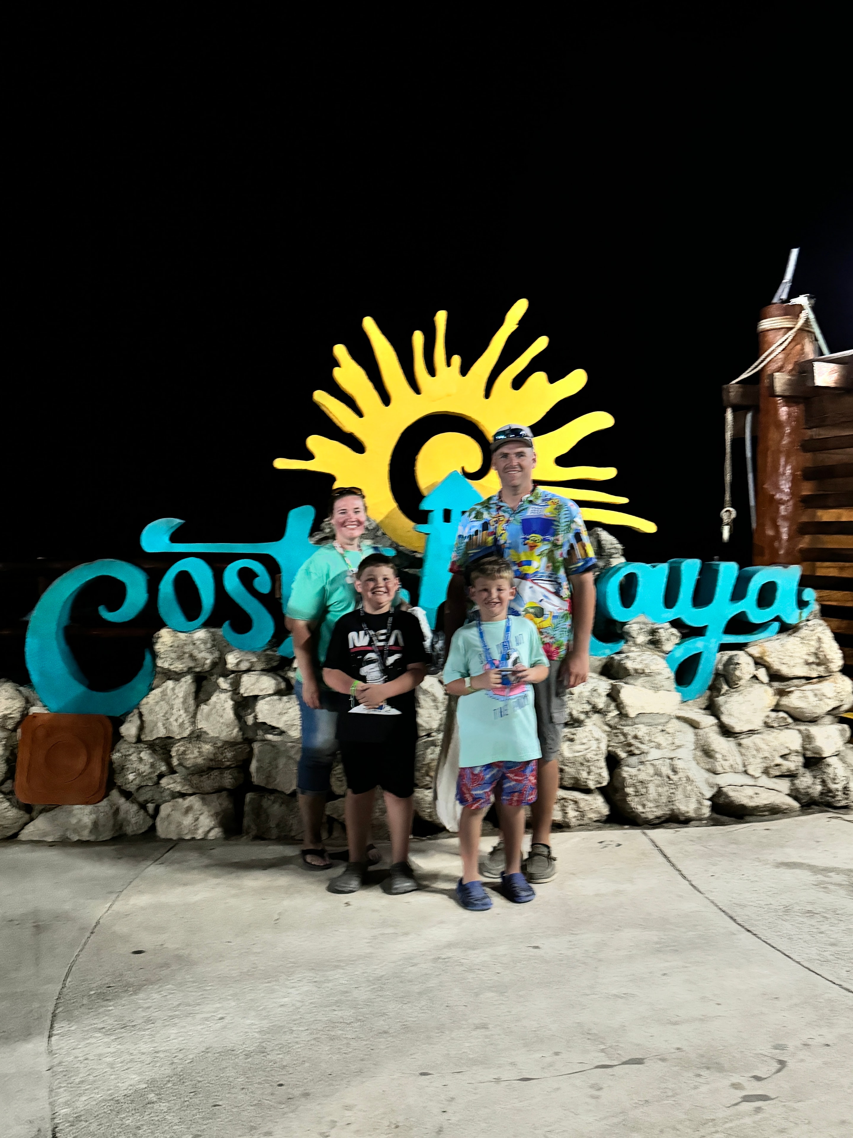 Family posing at the Cozumel sign