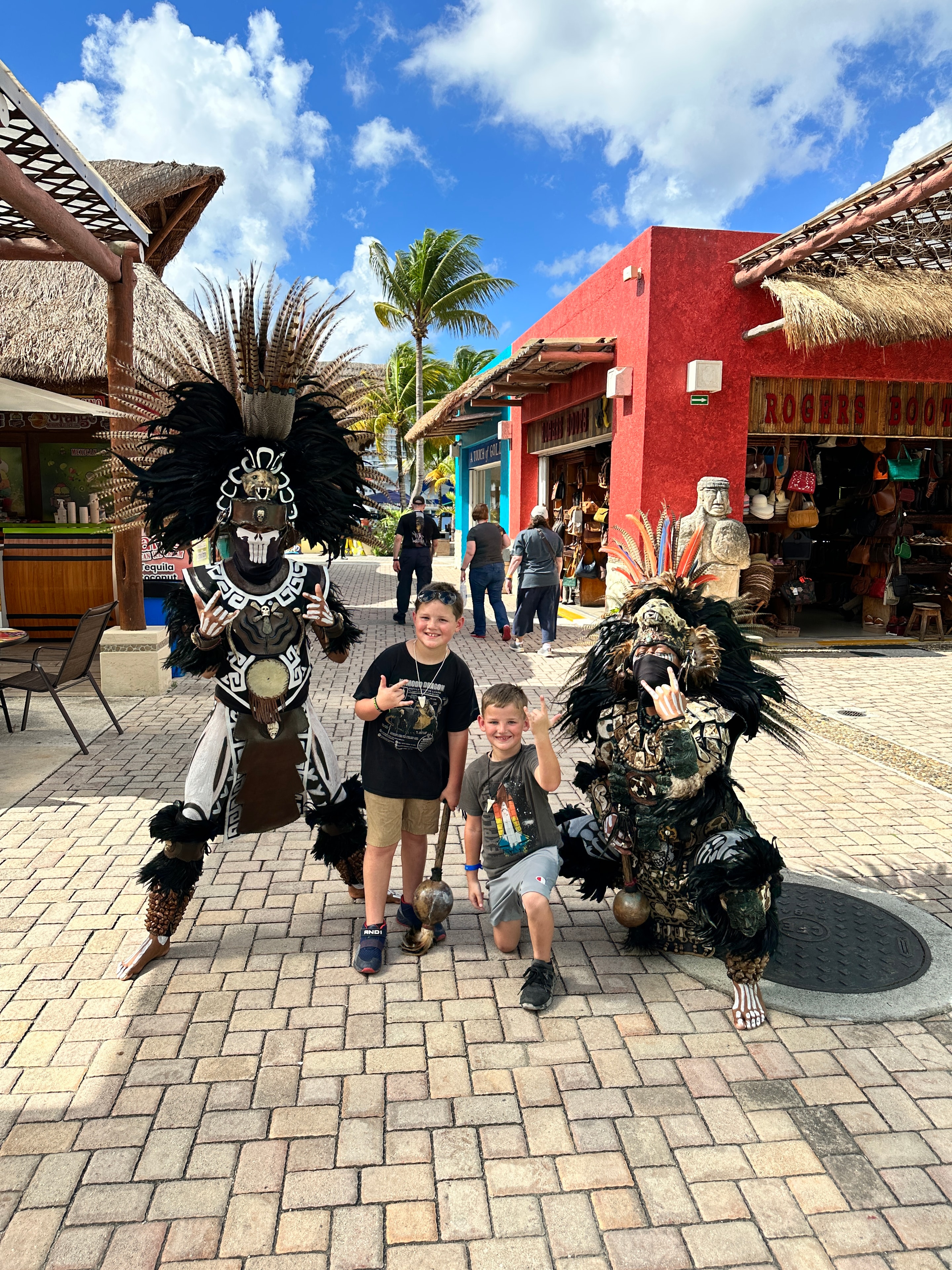 Kids posing with Aztec performers in Mexico